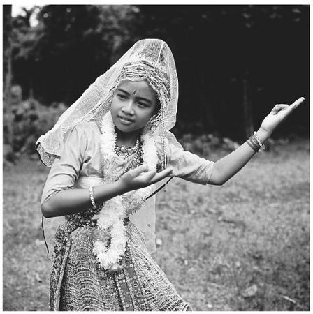 A young Bengali woman performs a traditional Manipuri dance