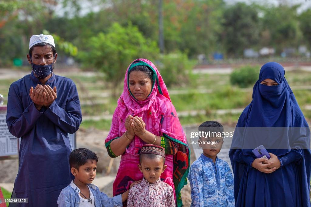 Family members offer prayers for their deceased relatives