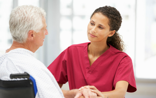 A nurse being compassionate with a patient.